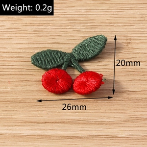 Detail view of 26mm x 20mm cherry embroidery patch with weight specification