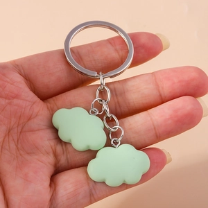 Detail of light green matte resin cloud pendants on a silver metal keychain