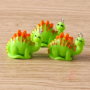 Three cute green resin dinosaur charms with orange spikes for DIY jewelry making