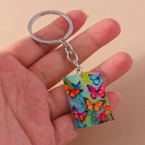 Detail of butterfly acrylic keychain featuring vintage serrated edges and metal ring