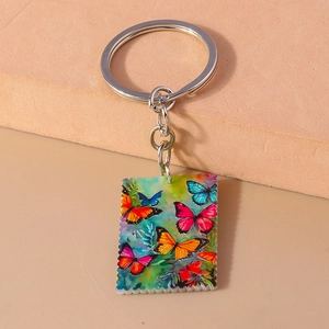 Macro shot of rectangular acrylic keychain with colorful butterfly patterns and metal ring