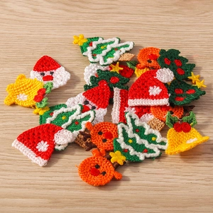 Group of assorted knitted Christmas patches on a natural wood surface showing fabric textures
