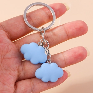 Close-up of blue cloud keychain with matte resin charms and silver metal ring