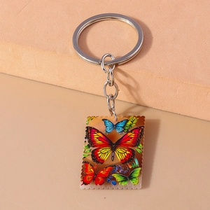Detail of square butterfly keychain with oil painting style and scalloped stamp edges
