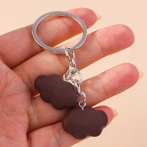 Detailed view of brown matte resin cloud charms on a silver metal keychain