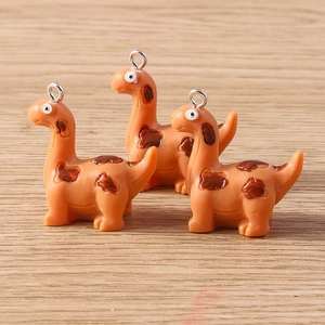 Three cute orange dinosaur resin charms with brown spots and silver metal hooks for DIY
