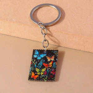 Detail of colorful butterfly oil painting keychain with stamp edge on acrylic pendant