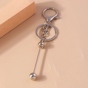 Detail of silver geometric dumbbell pendant keychain with spring D-ring buckle