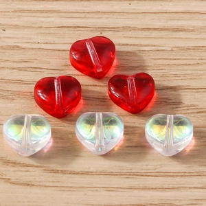 Macro view of heart-shaped colorful acrylic beads with vertical holes for DIY jewelry craft