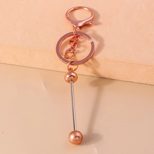 Macro shot of rose gold bead keychain featuring a lobster clasp and polished alloy finish