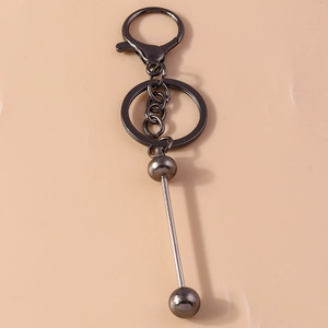 Industrial dark gray metal geometric bead keychain with lobster clasp on pink background