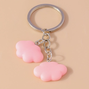 Detailed view of light pink cloud resin keychain with silver ring and matte finish surface