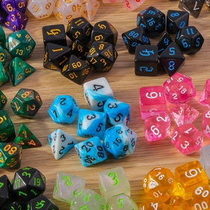 Flat lay of colorful polyhedral dice set on wood background for tabletop games