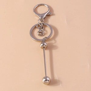 Detailed view of silver alloy geometric keychain with smooth double-ball metal pendant