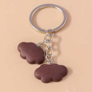 Detail of dark brown resin cloud charms with silver chain and metal keyring