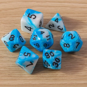 Close-up of blue and white marble resin polyhedral dice set on a light wood surface