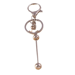 Golden geometric beaded keychain with lobster clasp and rotating ball bar pendant