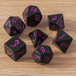 Detailed view of 7 black polyhedral DND dice with purple numbers on wood surface