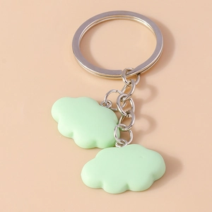 Detail of creative light green cloud pendants on a silver metal keychain with ring