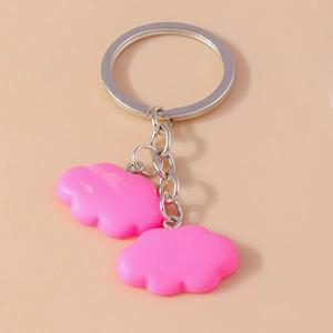 Detailed view of twin neon pink cloud resin pendants with silver metal keychains
