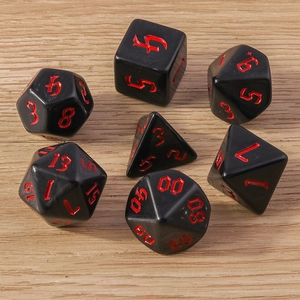 Close-up of 7-piece polyhedral dice set with black finish and red gothic numbering