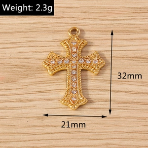 Detailed view of a 32x21mm gold cross pendant with crystal rhinestones and weight 2.3g