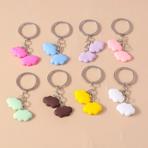 Flat lay of colorful cloud resin keychains in 8 vibrant pastel shades with metal rings