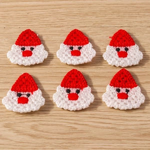 Close-up of 6 handmade crochet Santa Claus patches for DIY Christmas clothing decoration