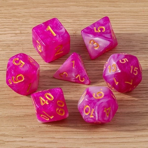 Macro view of 7-piece magenta marble resin dice set with gold numbers on wood