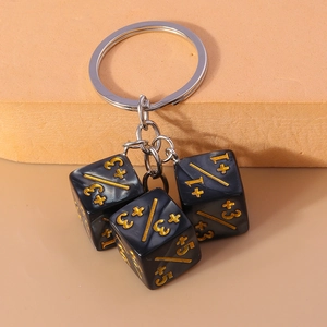 Macro view of a creative dice keychain featuring black resin cubes with gold numbers