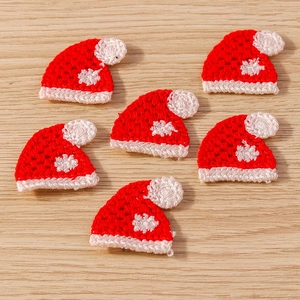 Close-up of mini knitted Christmas hats for DIY crafts and festive apparel decoration