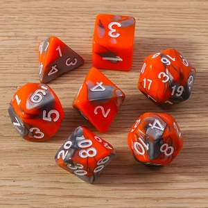 Macro shot of 7-piece orange and black marbled polyhedral resin dice set for tabletop games