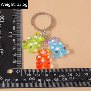 Detailed scale view of three colorful resin bear charms weighing 13.5g with silver ring