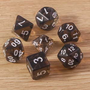 Set of 7 translucent dark grey resin polyhedral dice for DND on a wood background