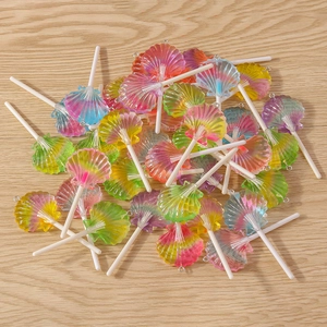 Macro detail of colorful shell-shaped resin lollipop charms with metal rings for DIY jewelry