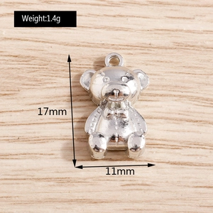 Macro detail of silver bear charm showing 17mm height and 11mm width for DIY jewelry