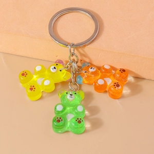 Detailed macro view of three colorful resin gummy bear charms with silver metal keychains