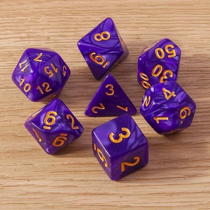 Close-up of purple marble polyhedral dice set with gold numbers on light wood surface