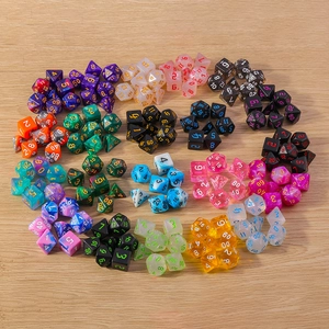 Detailed overhead view of multiple sets of colorful polyhedral RPG dice on wood background