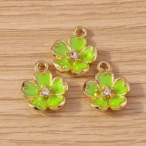 Three green enamel flower pendants with gold plating and center diamond for jewelry making