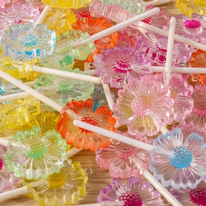 Macro detail of colorful daisy lollipop resin charms with metal loops for DIY jewelry