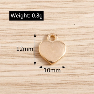 Close-up of golden heart alloy pendant with 12mm height and 0.8g weight dimensions