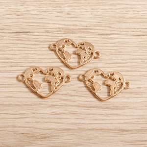 Three rose gold heart world map charms on light wood texture showing side hanging loops