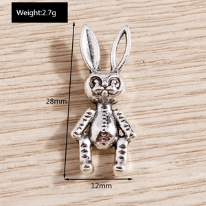 Macro detail of vintage silver-plated rabbit charm with antique finish and dimensions