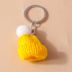Cute yellow knitted hat keychain with a white pom-pom and silver metal ring accessory