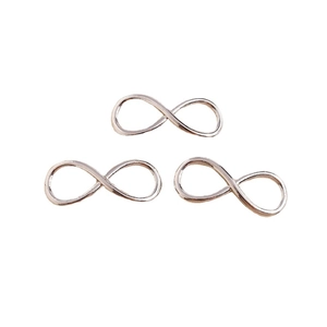 Three pieces of rose gold infinity symbol alloy pendants on a clean white background