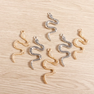 Set of snake shaped metal charms in gold and silver finish for DIY jewelry making