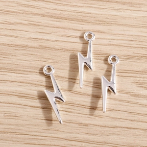 Detailed macro view of three silver lightning bolt charms for DIY jewelry making