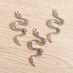 Detailed view of silver snake pendants featuring fine scales for DIY jewelry making