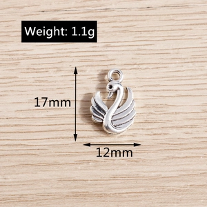 Macro view of swan animal charm showing silver metal texture and 17x12mm dimensions